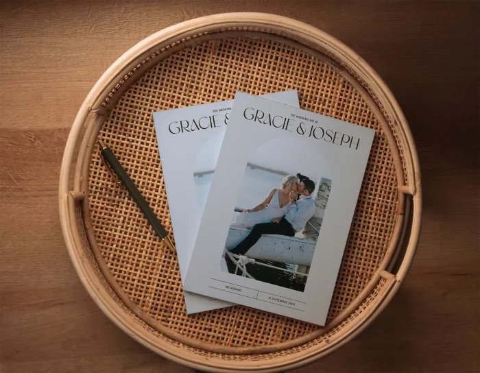 Wedding Magazine Cover Modern Arch featuring arches and curves throughout the magazine cover and page layout design. 2 magazines on display on the coffee table.
